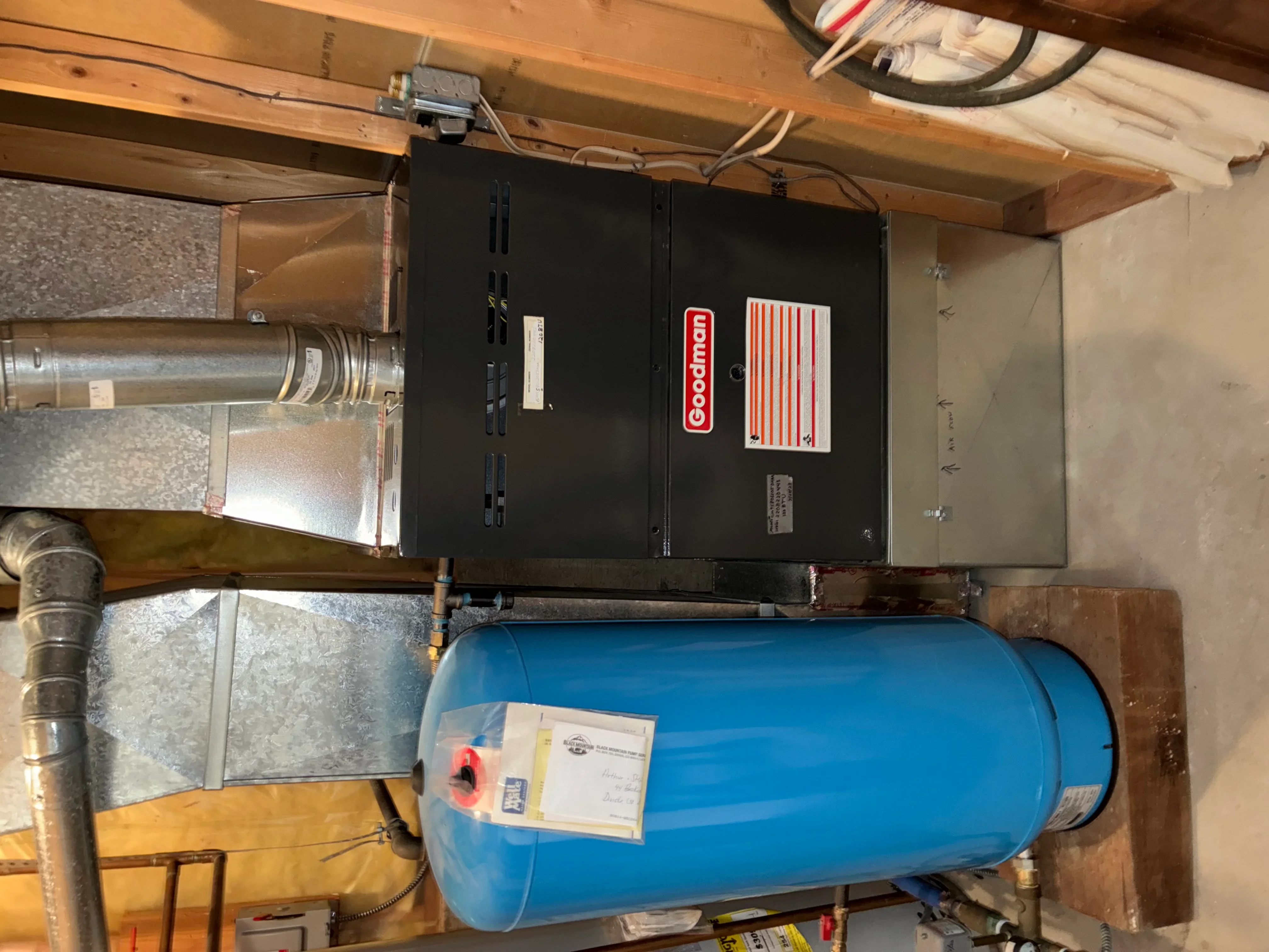 Boehman boiler unit with blue pressure tank and copper piping in basement installation