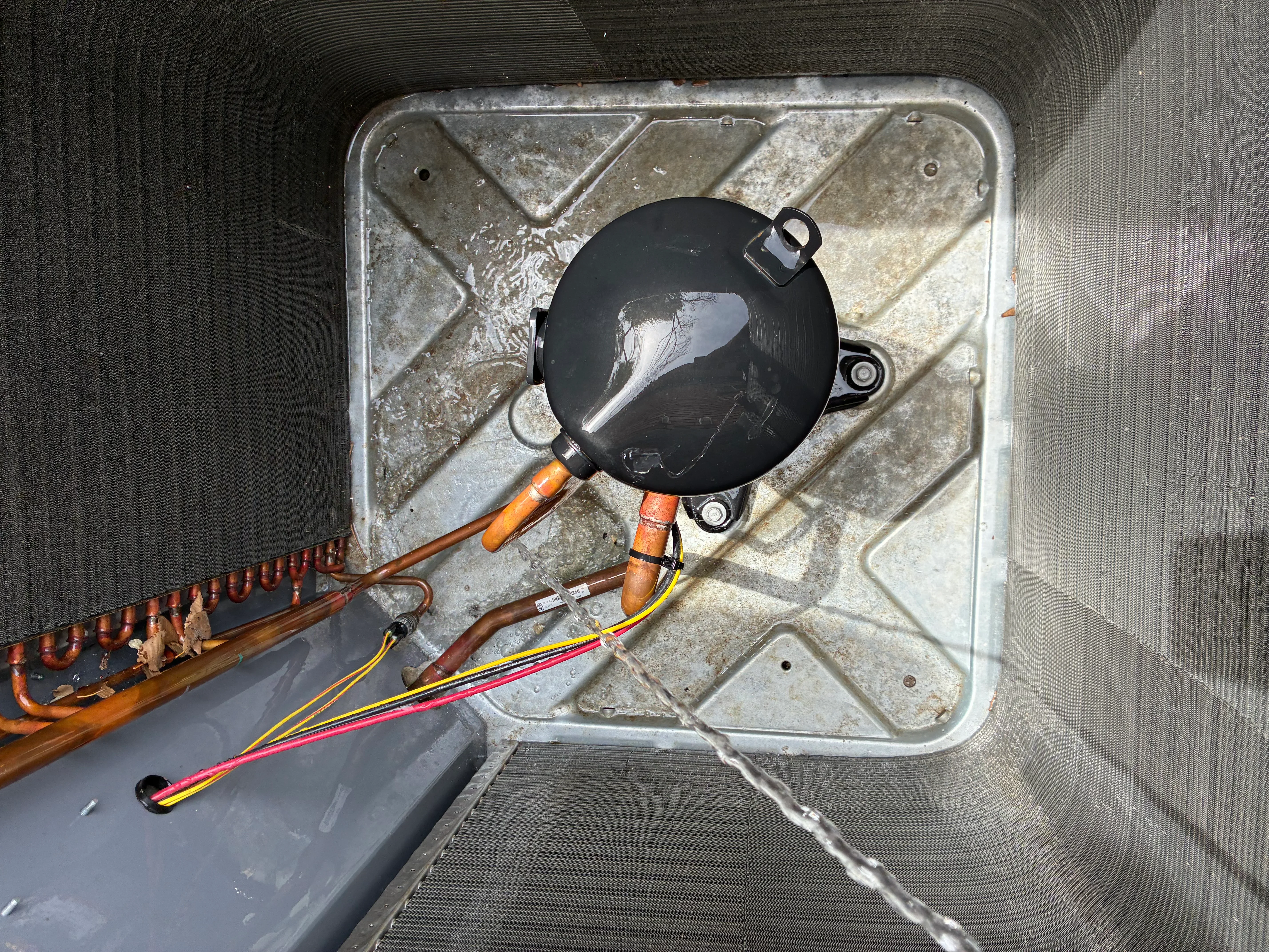 HVAC ductwork installation with black damper, copper fittings, and color-coded wiring
