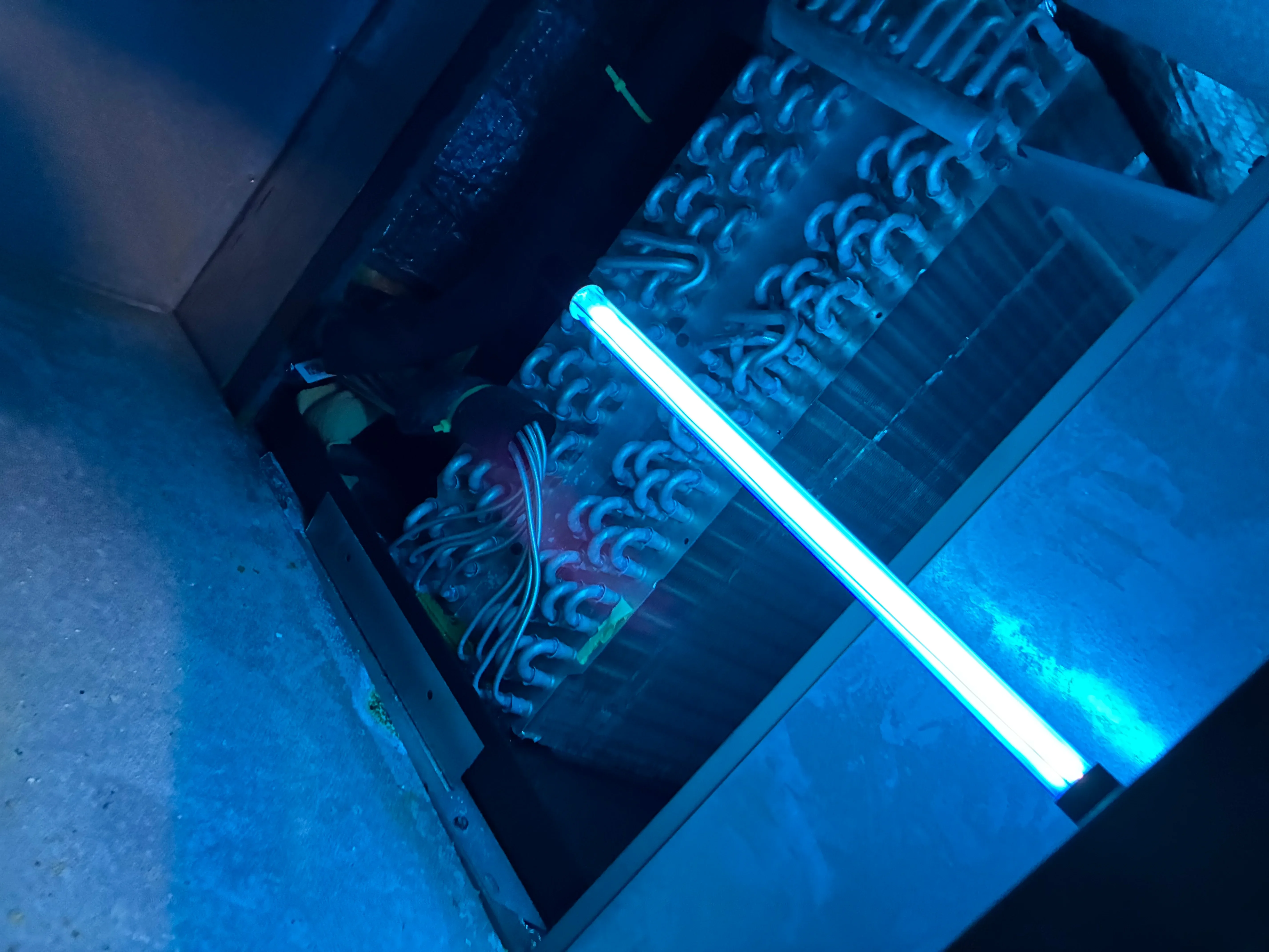 Commercial HVAC ductwork with blue LED inspection lighting installed in mechanical space